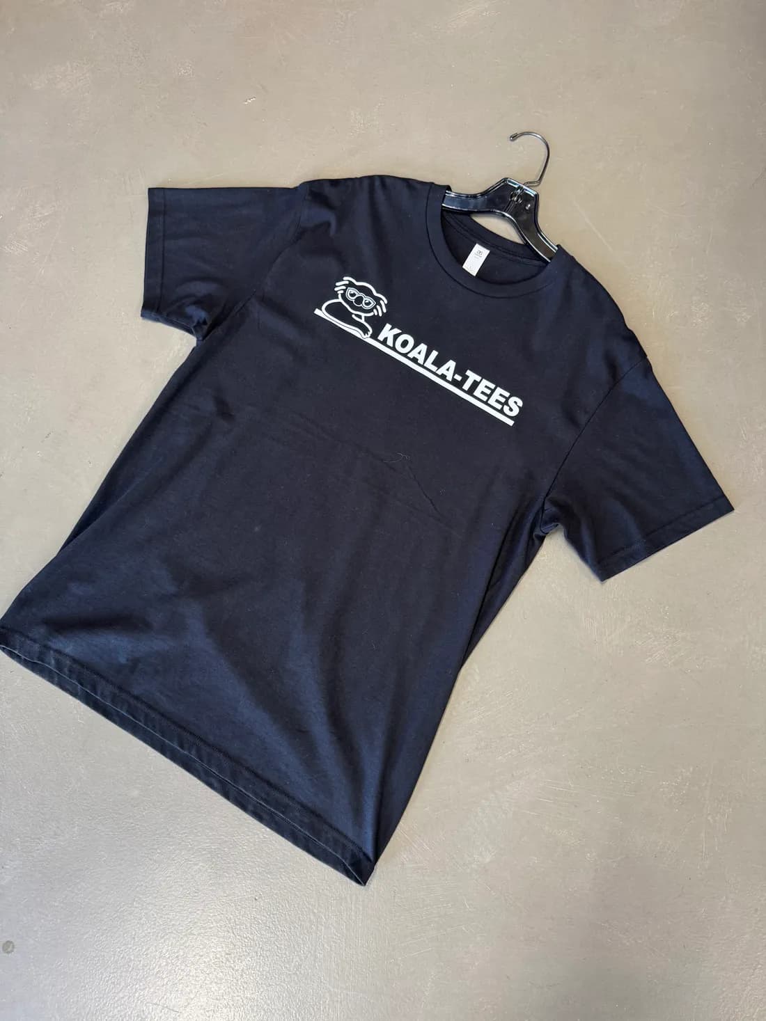 White DTF Koala-Tees logo printed on a black AS Colour 5050 tee