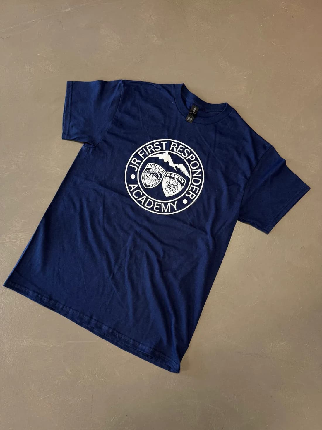 Navy Gildan Heavy Cotton tee with the Jr First Responder Academy logo featuring Sandy police and fire badges