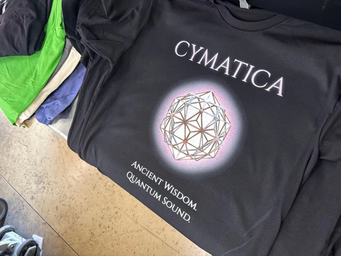 Black Next Level 3600 tee with a DTG-printed Cymatica geometric design