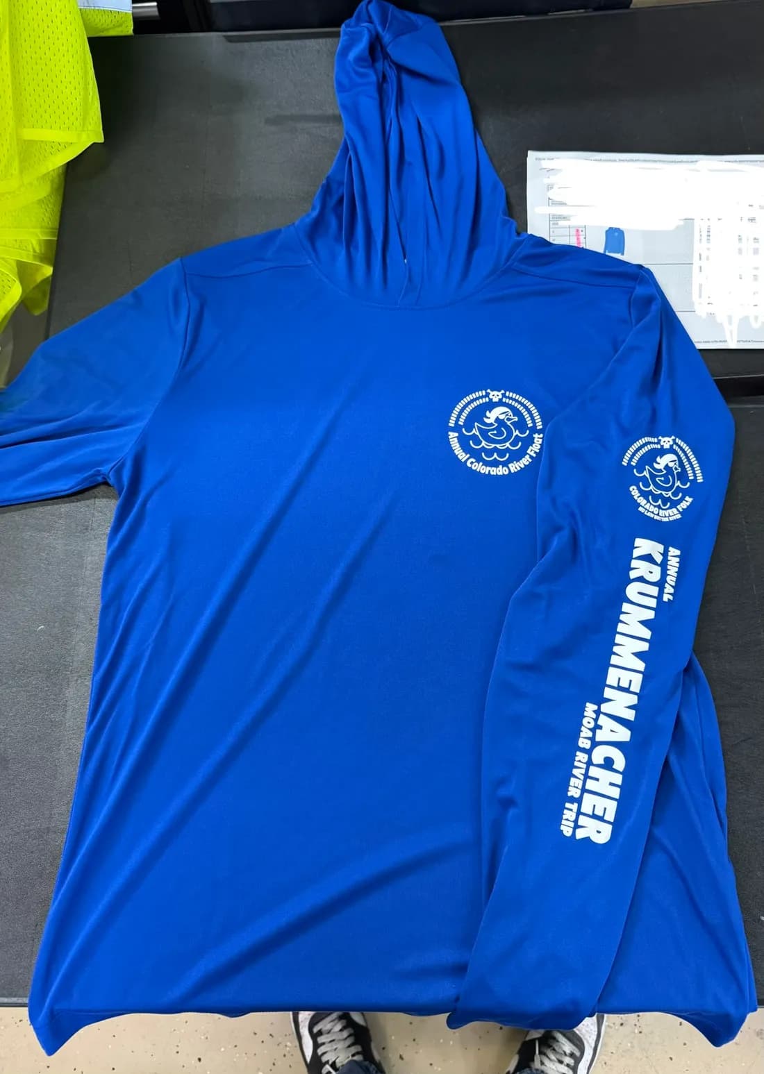 Royal blue Sport-Tek ST358 hooded pullover with a white left-chest print and a sleeve print for an annual Moab river trip