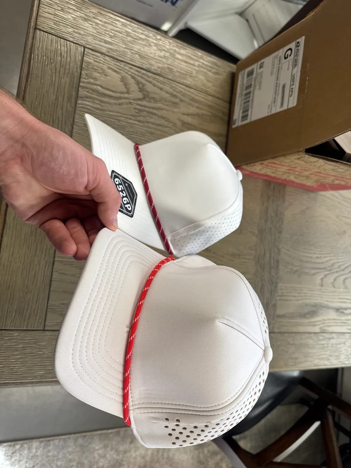 Two blank white rope-front performance caps with laser-perforated panels