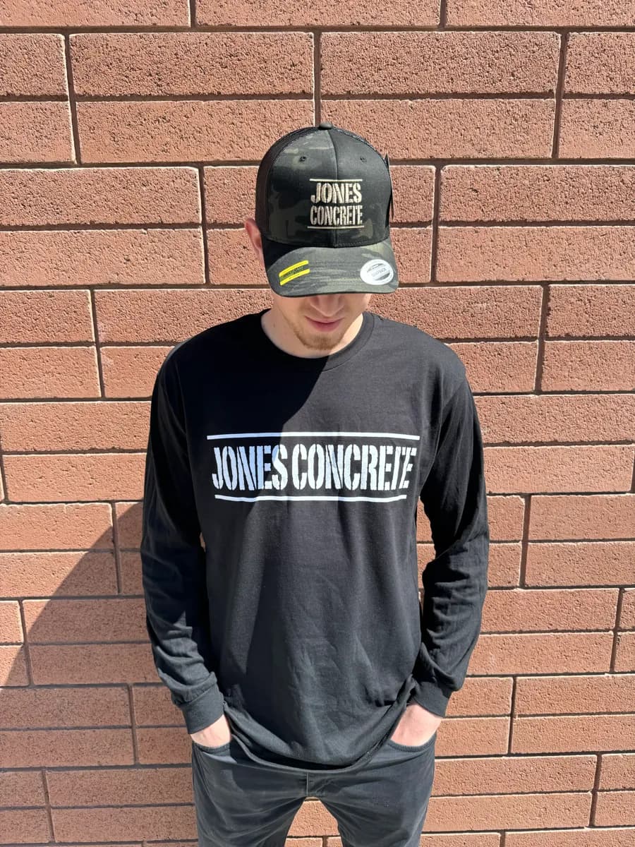 Man wearing a camo Jones Concrete hat and matching black Jones Concrete long-sleeve shirt
