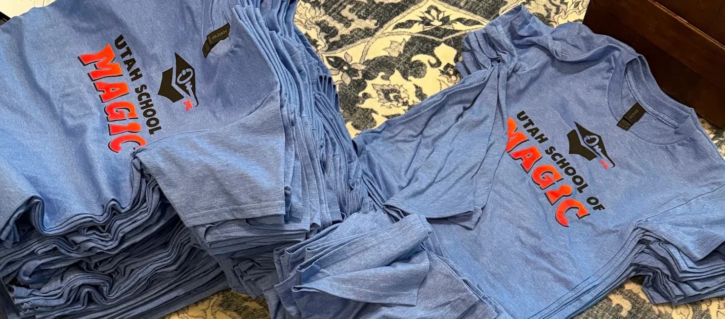 Scott's actual order — Utah School of Magic tees printed by Koala-Tees on heather blue Gildan shirts