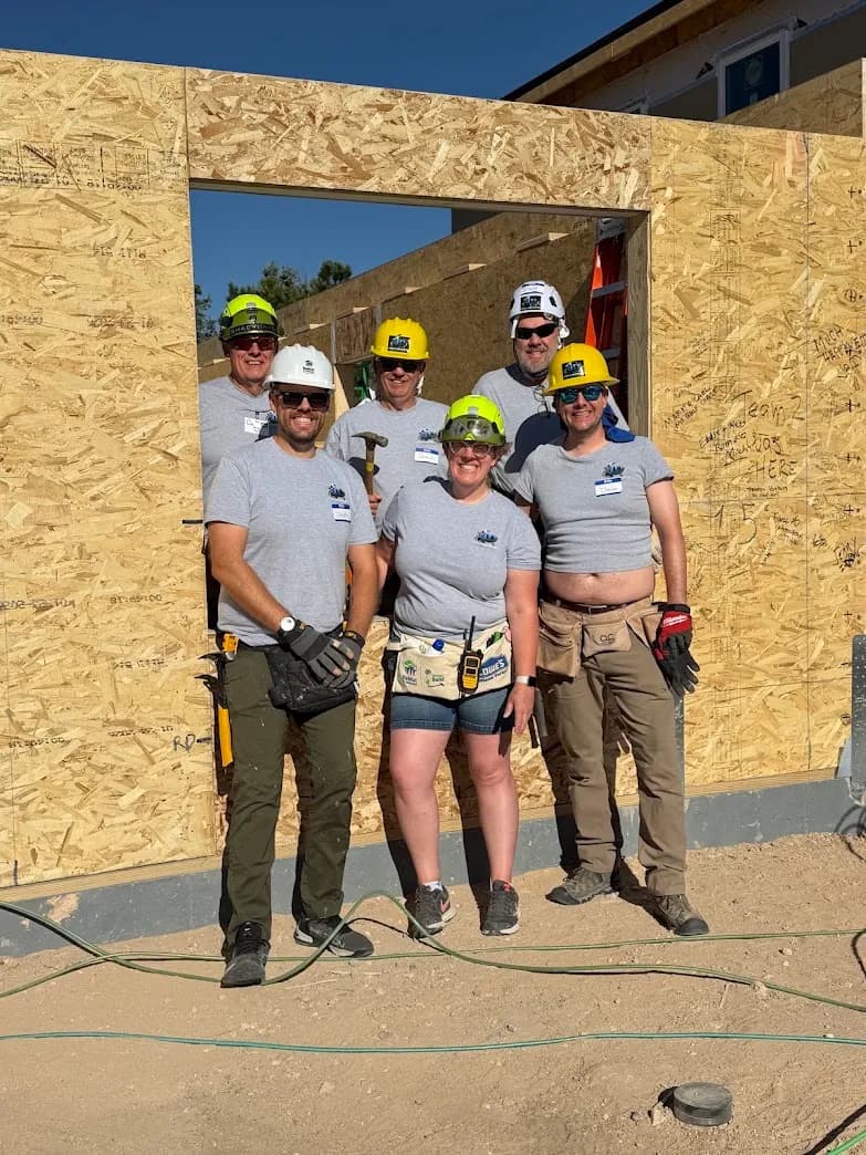 Crew wearing matching custom tees from Koala-Tees on a home construction site