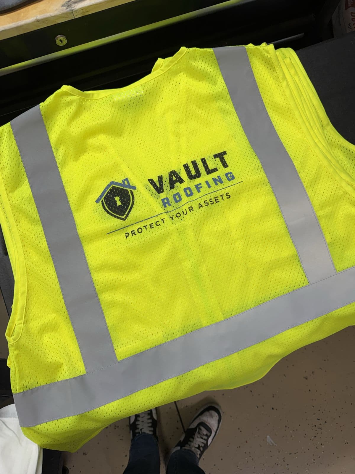 Hi-vis safety vest printed with the Vault Roofing logo by Koala-Tees